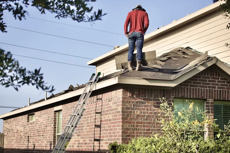 Professional roofer working on a residential roof in Featherock